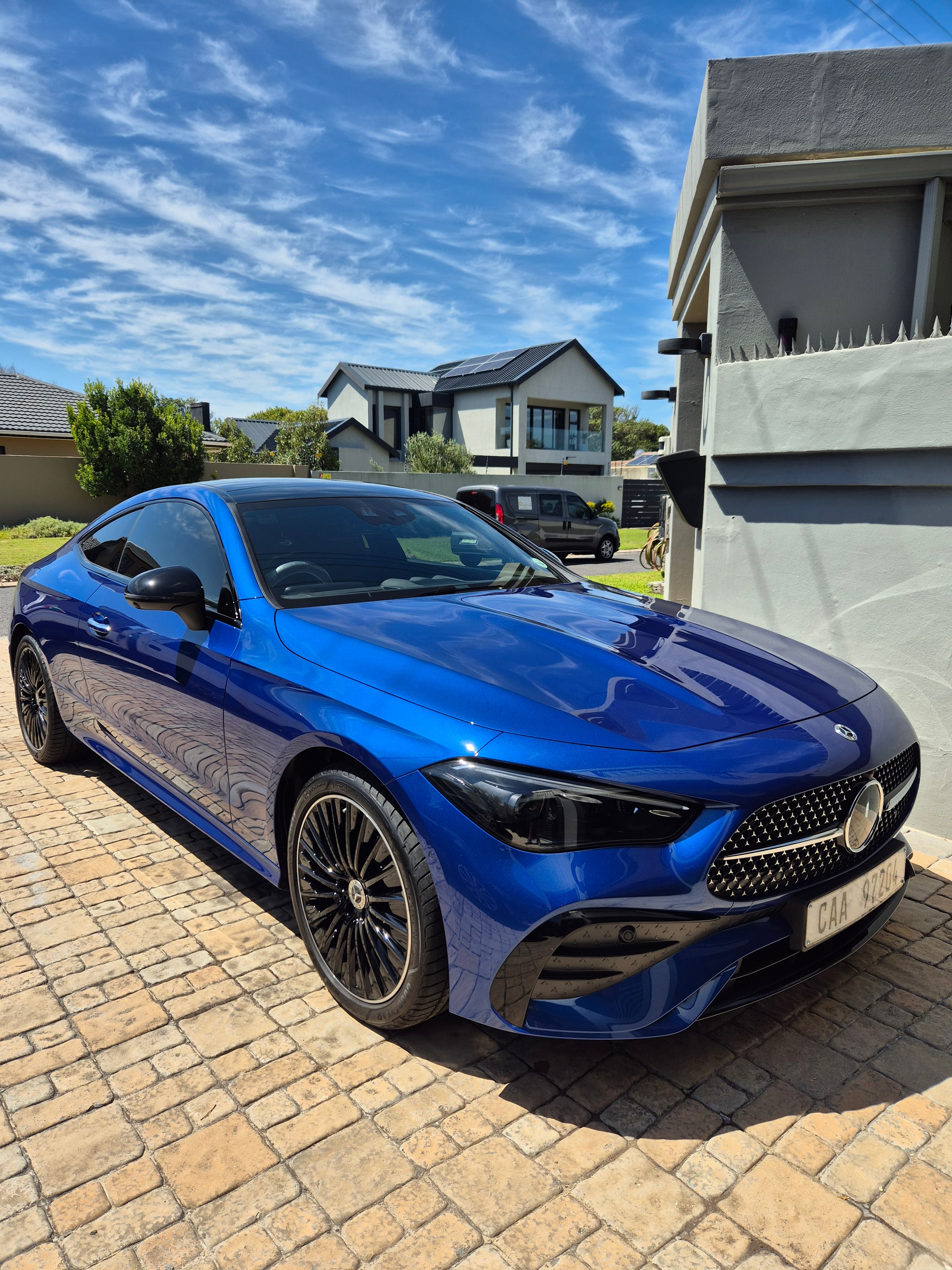 Blue Bentley freshly detailed — mirror paint in full sun